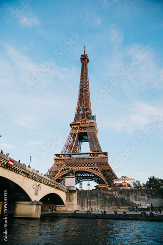 View of the Eiffel Tower from a boat in the Seine River on a Clear Blue Day