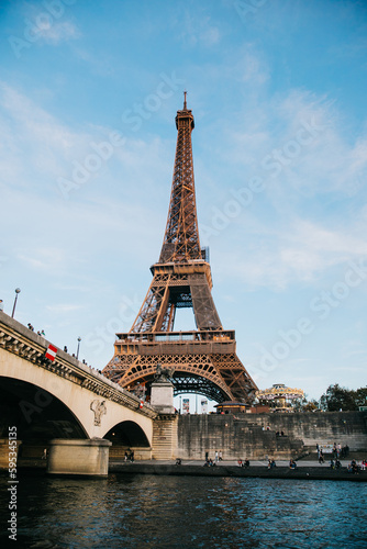 View of the Eiffel Tower from a boat in the Seine River on a Clear Blue Day