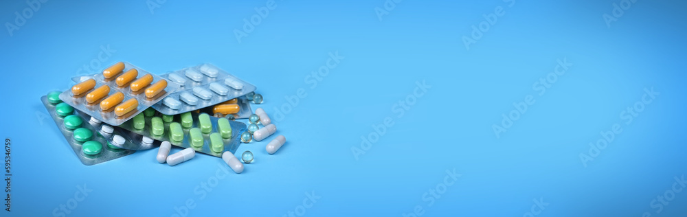 The concept of medicine. A set of pills. a set of medicines. Various capsules. on a blue background, the concept of pills, buying medicines and shopping. The concept of medicine. A set of pills. a set of medicines. Various capsules. on a blue background, the concept of pills, buying medicines and shopping.