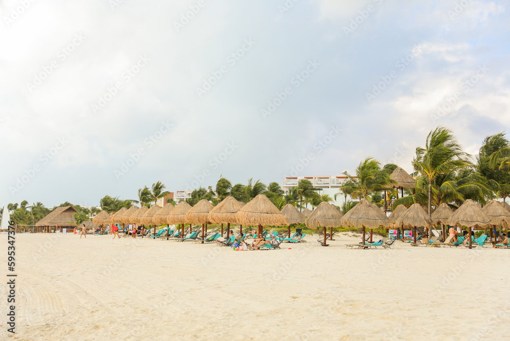 palapa sun roof beach umbrella by the beach symbolizes relaxation, shade, and protection. It represents a tropical, beachy atmosphere and the desire to escape from the sun's harsh rays