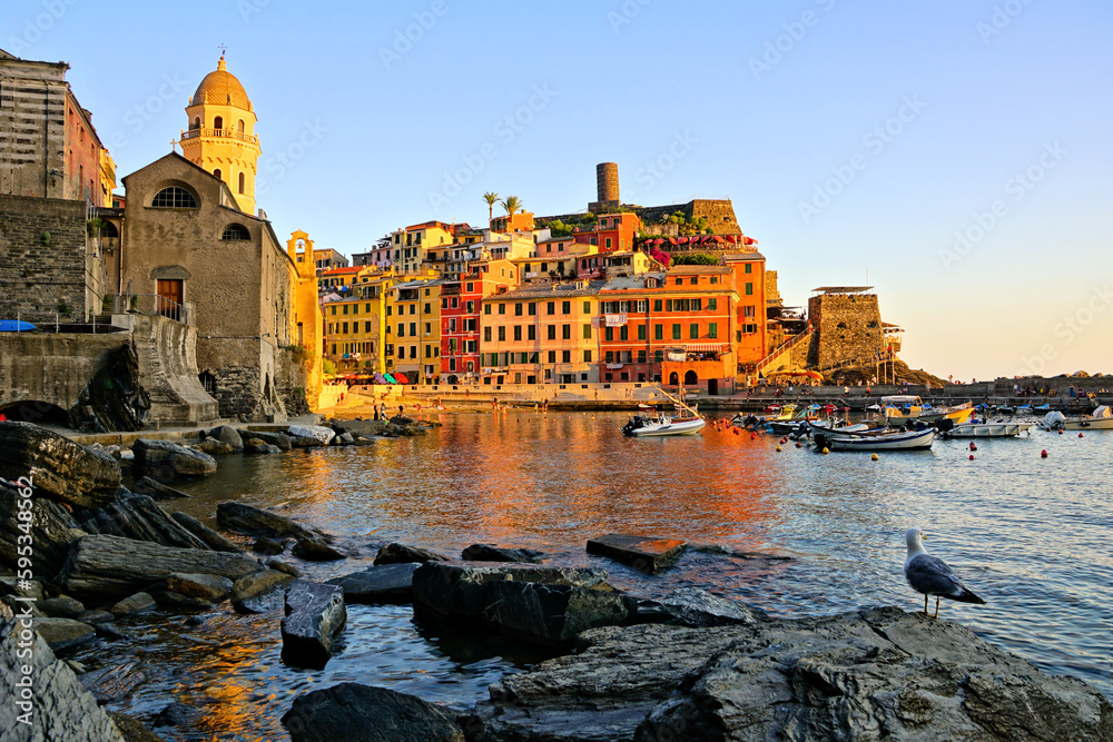 Warm golden sunset view of the harbor of Vernazza, Cinque Terre, Italy