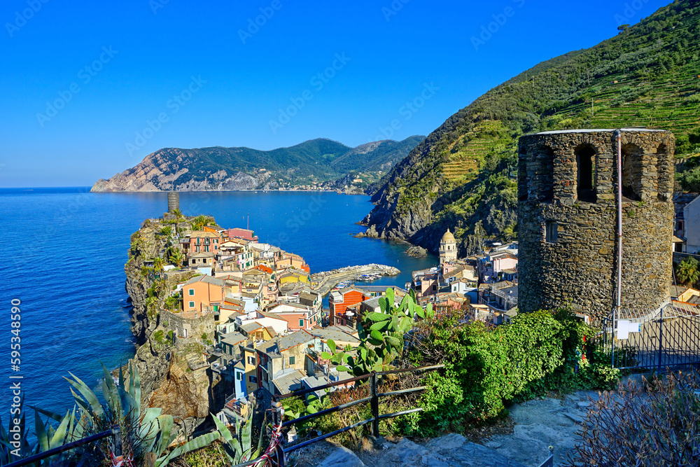 Beautiful Cinque Terre village of Vernazza, Italy. View from above overlooking the town, watch tower and blue sea.