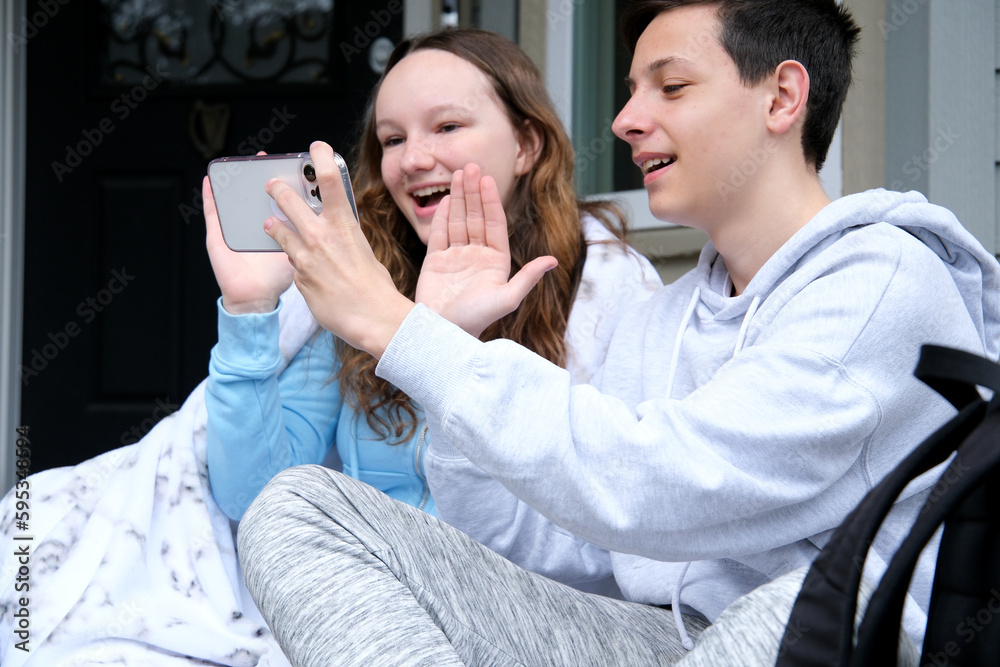 Beautiful young couple relaxing on a couch at home, using laptop computer, taking a selfie. High quality photo Beautiful young couple relaxing on a couch at home, using laptop computer, taking a selfie. High quality photo