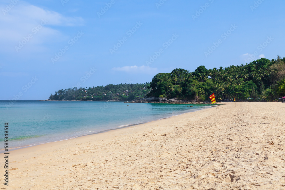 Beautiful Surin beach in Choeng Thale city, Phuket, Thailand with white sand, turquoise water and palm trees