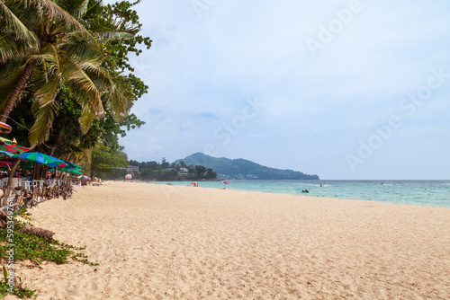 Fototapeta Naklejka Na Ścianę i Meble -  Beautiful Surin beach in Choeng Thale city, Phuket, Thailand with white sand, turquoise water and palm trees