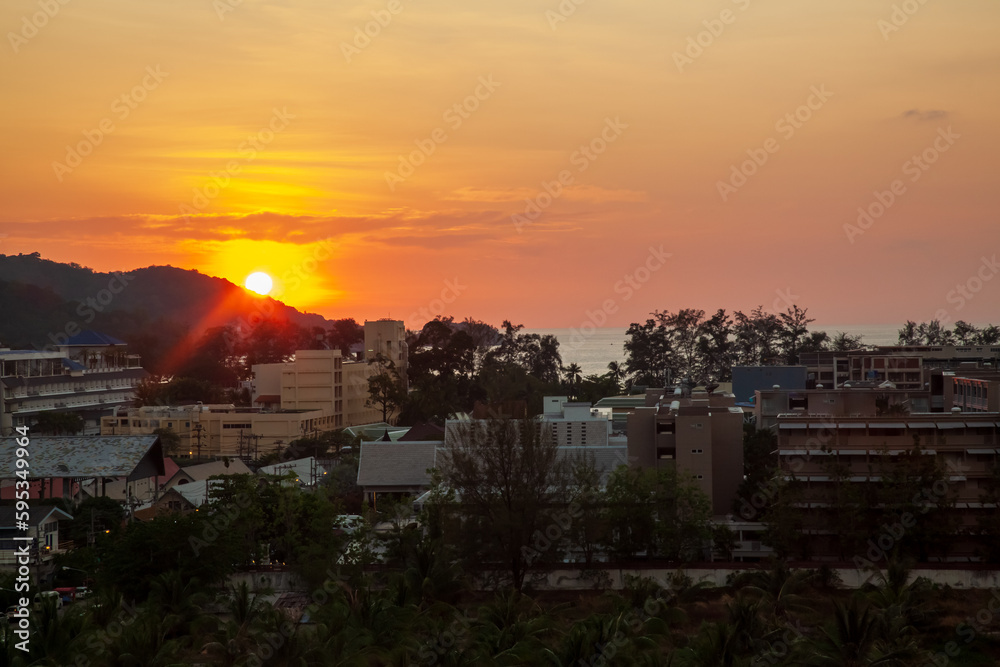 sunset view from the roof of the city of patong in thailand on the island of phuket with hotels and buildings for tourists