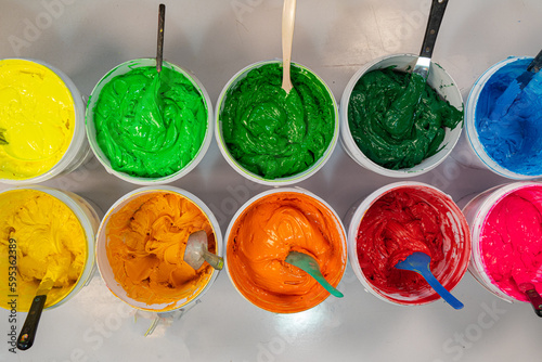 Quadro em tela Top view, colorful fabric printing inks in white buckets