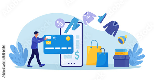 Online shopping. Man purchasing clothes from website, virtually insert credit card to phone for payment. Shopper buying on internet sale. Special offer. Buyer picked goods, paid with mobile banking