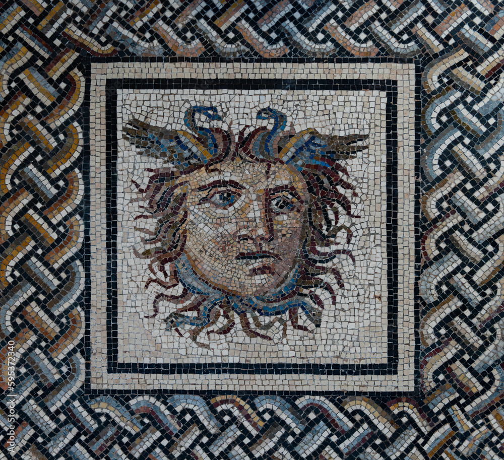 Ancient Italian Roman mosaic, pattern and head of a woman. Background on the theme of archeology, antiquity, history and antiquity.