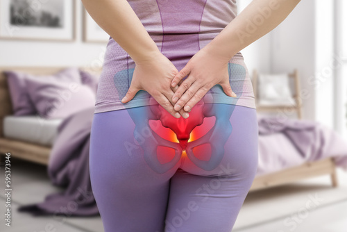 Tailbone pain, coccyx fracture, woman suffering from coccygodynia at home photo