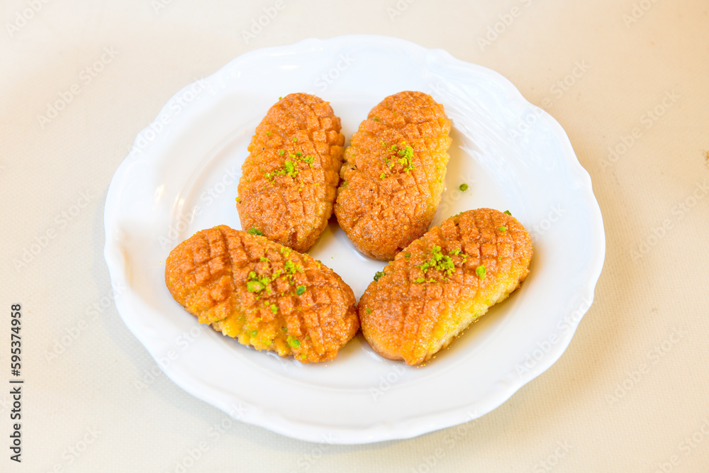 Turkish Dessert Sobiyet Baklava, kadayif, mussels baklava and classic baklava with Pistachio . Cevizli, Fistikli Baklava, top view. Turkish Dessert Sobiyet Baklava, kadayif, mussels baklava and classic baklava with Pistachio . Cevizli, Fistikli Baklava, top view.