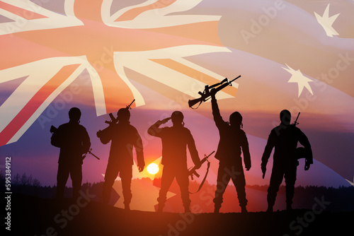 Silhouettes of soldiers on background of Australia flag and the sunset or the sunrise background. Anzac Day. Remembrance Day.