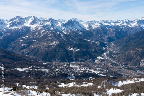 view of Oulx city in the mountains (Susa Valley, Piedmont, Italian Alps) in winter with snow
