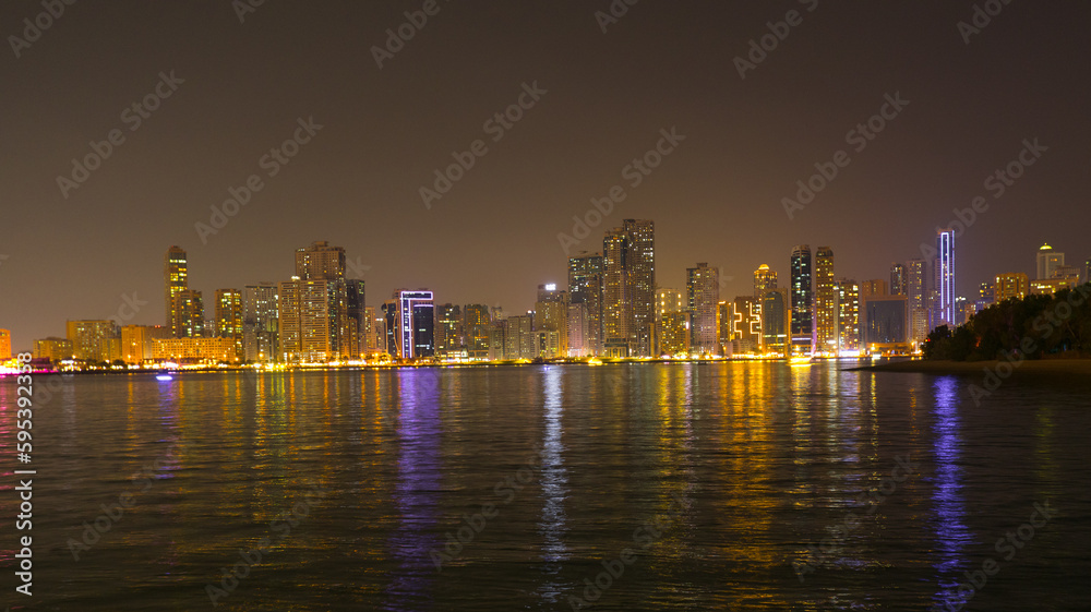 Fototapeta premium Night landscape of the embankment of the emirate of Sharjah, United Arab Emirates
