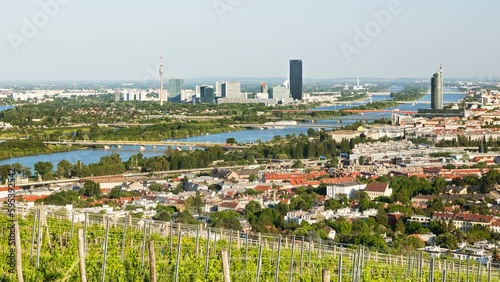 Timelapse view from a vineyard hill over Vienna, Austria to the Danube river, International Centre and Donaucity, zooming in.