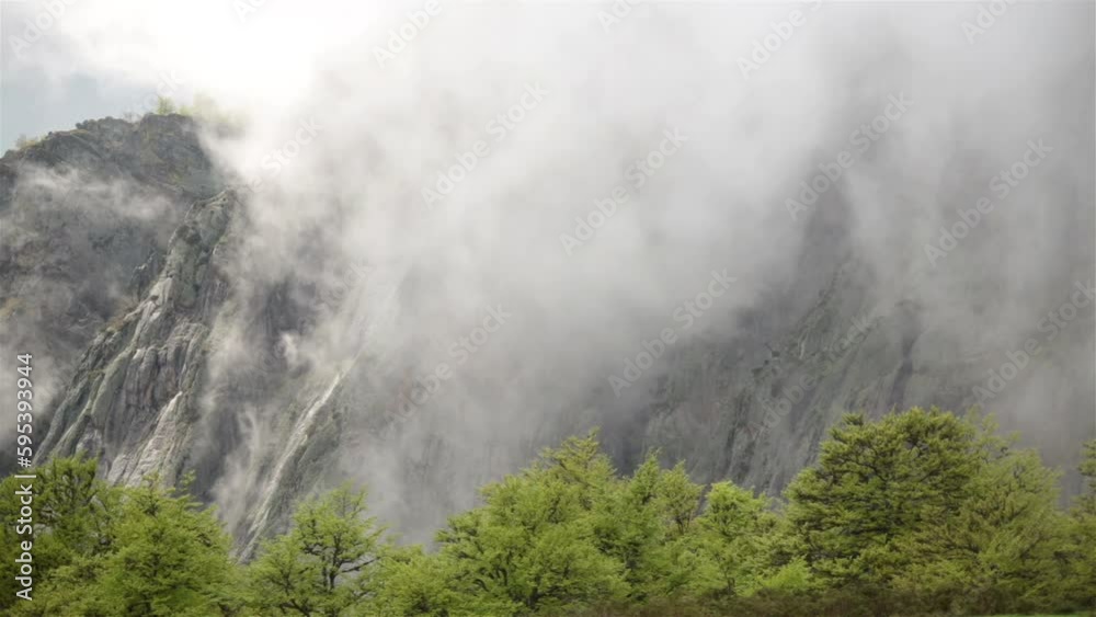 Sun breaking through fog rolling up mountain forest ridge Asturias Spain 4k Sun breaking through fog rolling up mountain forest ridge Asturias Spain 4k