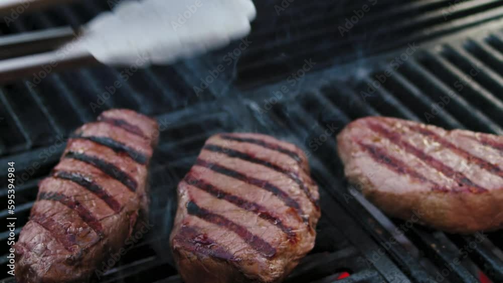 Barbecue dry aged angus sirloin beefsteak grilled as close-up on a charcoal grill with fire and smoke – video and audio Barbecue dry aged angus sirloin beefsteak grilled as close-up on a charcoal grill with fire and smoke – video and audio