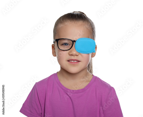 Girl with eye patch on glasses against white background. Strabismus treatment