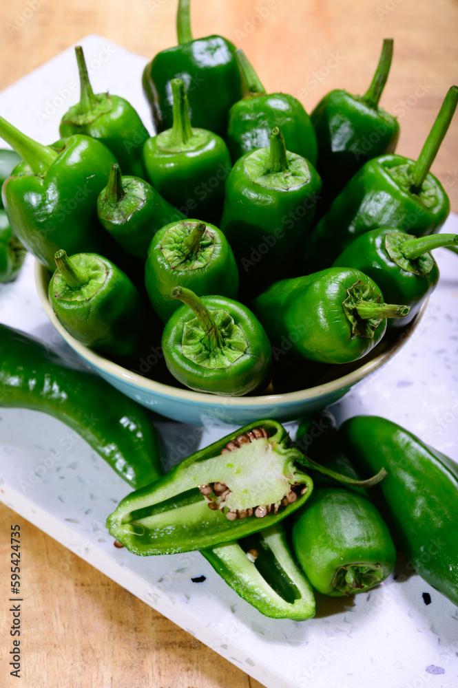 Fresh green mild padron pepper pementos, ready for grill or to be fried with olive oil, traditional snack in Galicia, Spain Fresh green mild padron pepper pementos, ready for grill or to be fried with olive oil, traditional snack in Galicia, Spain
