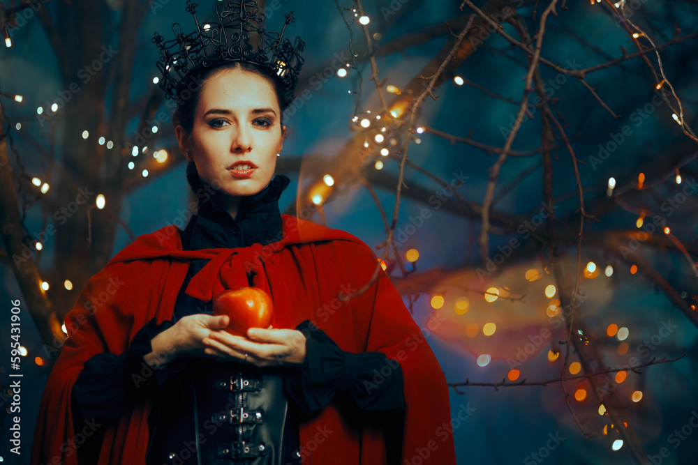 Evil Queen Holding a Red Poisonous Apple as Bait. Fantasy fairy tale