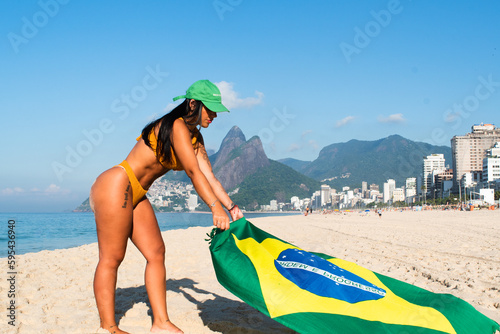woman on the beach with brazilian flag