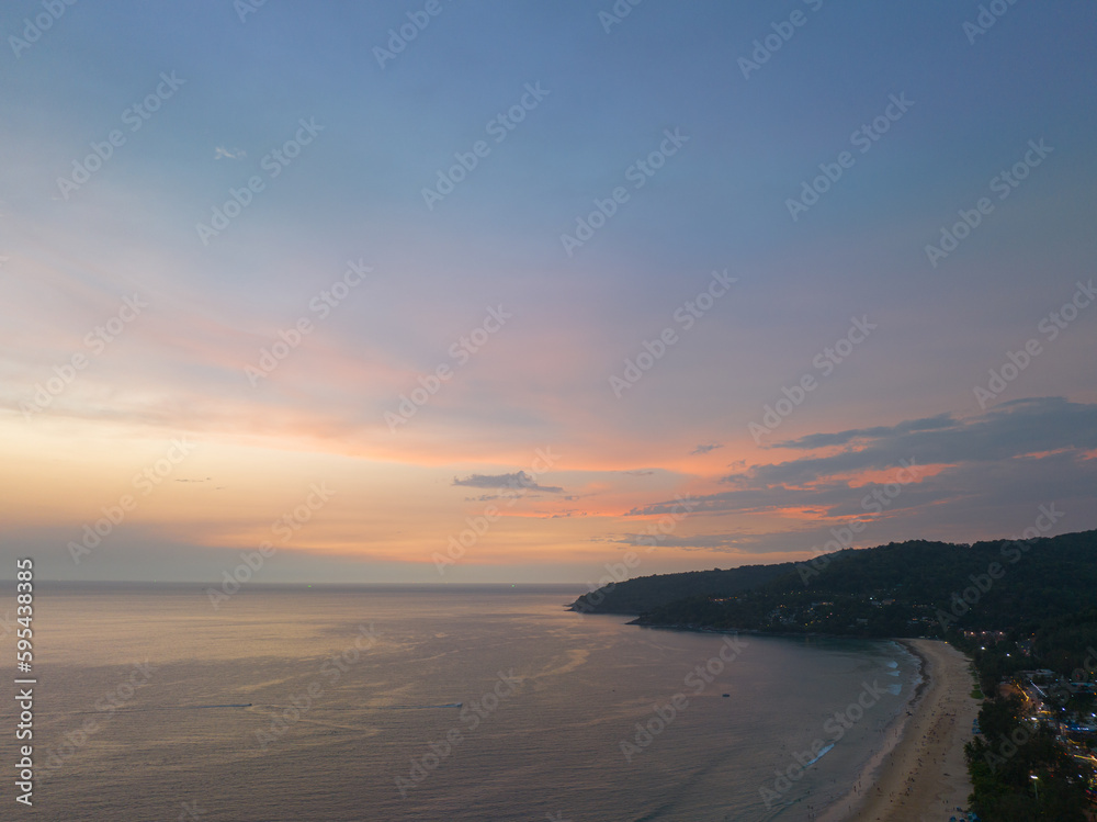 aerial view reflection of scenery romantic sky of sunset at Karon beach..reflection amazing sky of sunset in the swamp next to the beach..colorful sky background. amazing sunset over sea