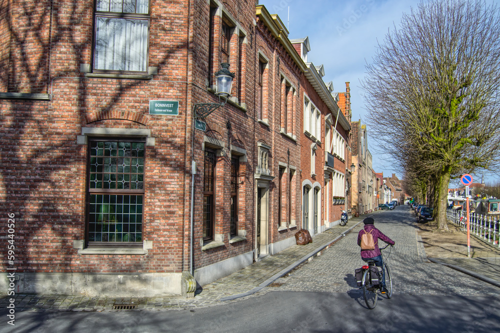 brick buildings on corner in Bruges Belgium with generic biker