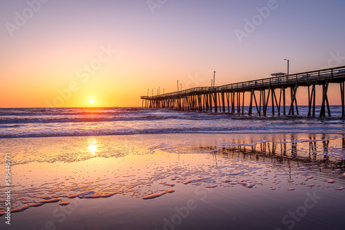 Venerable wood fishing pier in Virginia Beach at sunrise. © Chansak Joe A.