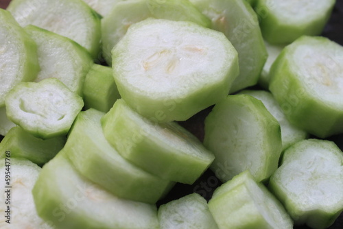 Close up of sliced  luffa acutangula vegetables on a wooden board