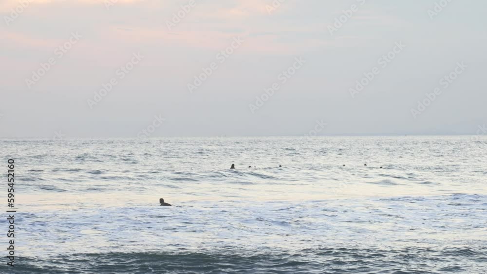 Beach, water and surfer people swimming in the distance on a summer vacation vacation in retirement with freedom on the Indonesian island of Bali Beach, water and surfer people swimming in the distance on a summer vacation vacation in retirement with freedom on the Indonesian island of Bali