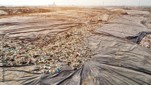 A landfill is a site for waste disposal where trash is buried in layers, and covered with soil. Proper management and monitoring are essential to prevent contamination of soil, water, and air.
 photo