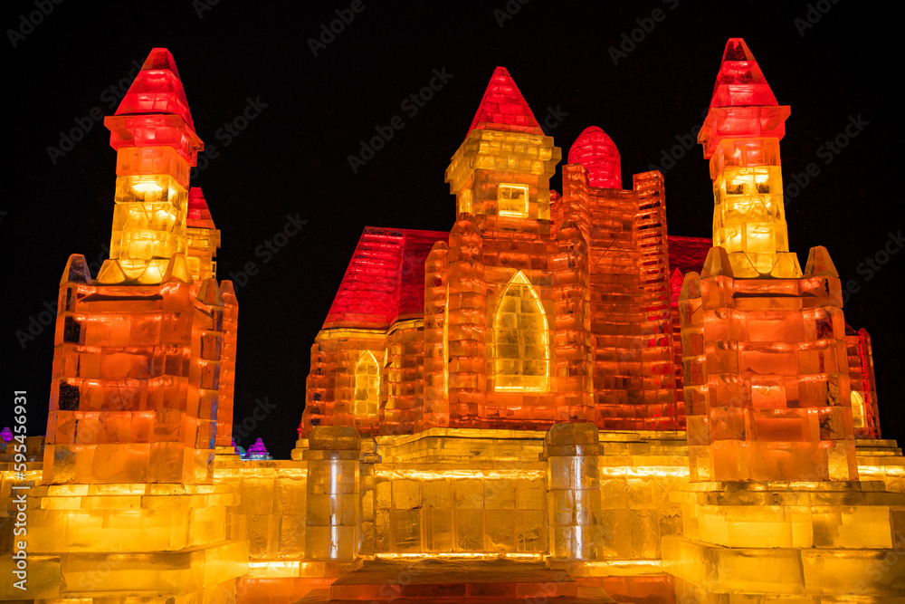 January, 1st, 2022. HARBIN, CHINA. Orange and red lit castle in ...
