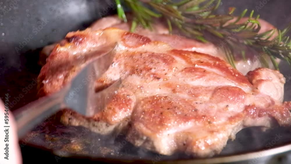 slow motion shot of Cooking chief flip rib eye steak with herbs on grill pan. High quality FullHD footage slow motion shot of Cooking chief flip rib eye steak with herbs on grill pan. High quality FullHD footage
