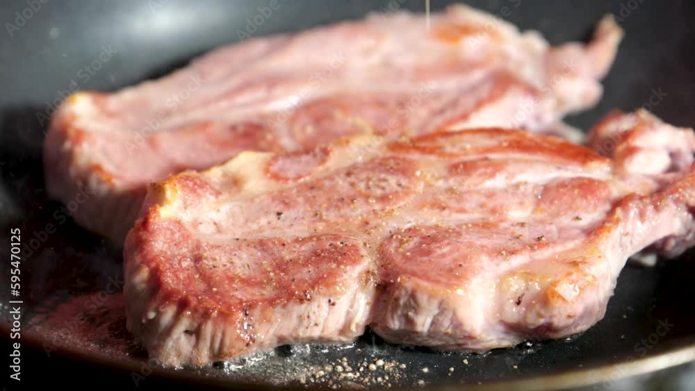 The cook flips the chicken meat in the frying pan. High quality FullHD footage