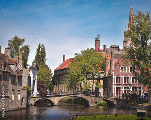 View of bridge over Bruges canal in sunny day