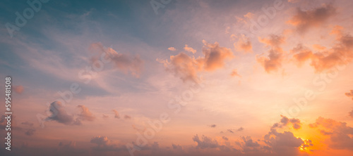 Beautiful sunset sky above clouds with dramatic light. Beautiful sunset sky. Nature sky backgrounds, majestic sunrise sundown sky background with gentle colorful clouds © icemanphotos