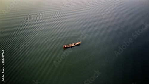 arial drone view of wooden boats moving in chilika lake in deep water