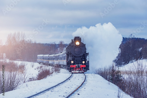 Retro steam train moves at winter morning time. © serjiob74