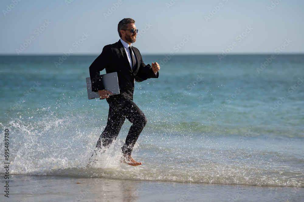 Excited businessman in wet suit run in sea. Funny business man, crazy comic business concept. Remote online working. Crazy summer business. Fun business lifestyle. Funny freelance businessman. Excited businessman in wet suit run in sea. Funny business man, crazy comic business concept. Remote online working. Crazy summer business. Fun business lifestyle. Funny freelance businessman.