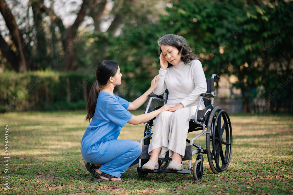 Elderly asian senior woman on wheelchair with Asian careful caregiver. Elderly asian senior woman on wheelchair with Asian careful caregiver.