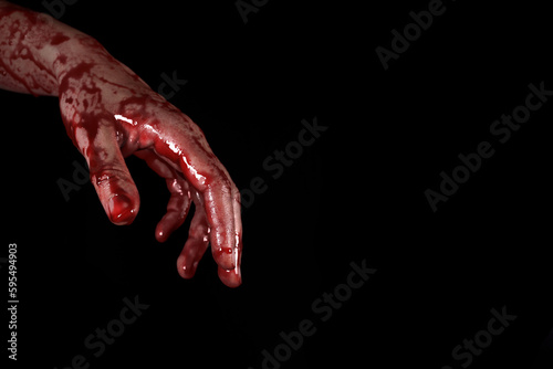 bloody hand on a black background, the concept of self-defense, murder, nightmares, halloween. copy space for text © Michael