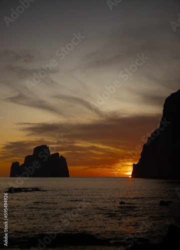 super sunset in the south of sardinia in front of the stack of sugar loaf, masua, iglesias 