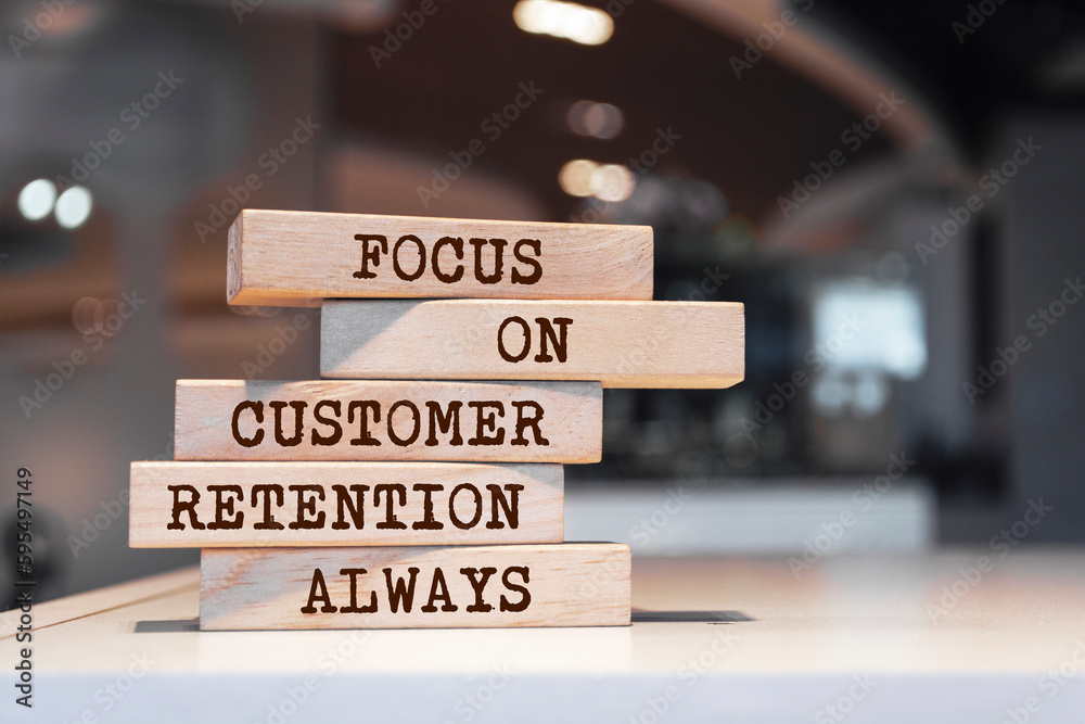 Wooden blocks with words 'Focus on customer retention always'. Business concept