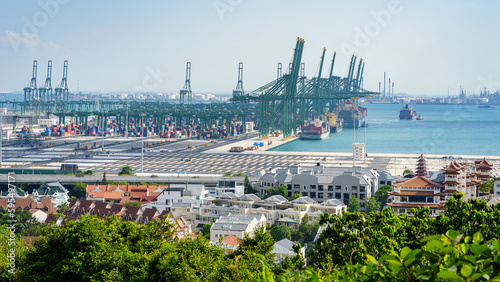 The cranes in the port of Pasir Panjang unloading containers from cargo ships passing by Singapore on the way to the Straits of Malacca. 