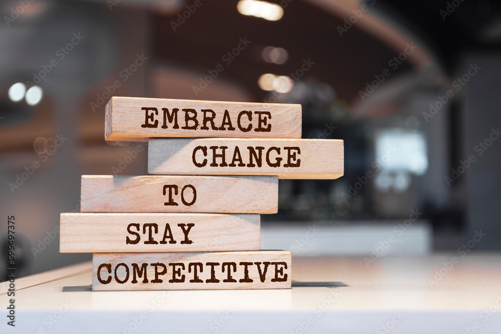 Wooden blocks with words 'Embrace change to stay competitive'. Business concept