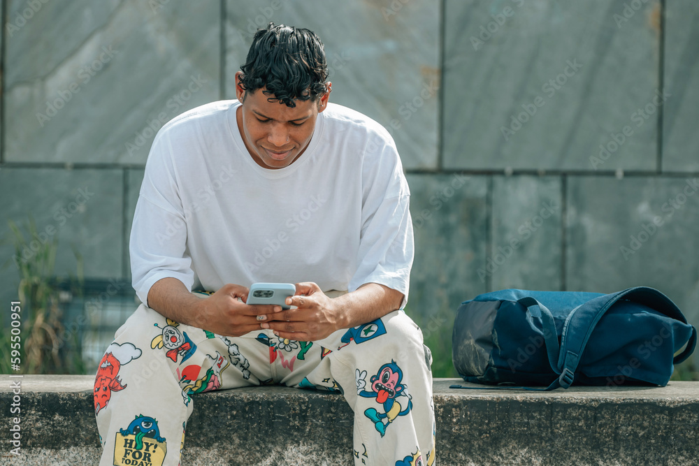 Obraz premium young latino man with mobile phone in the street