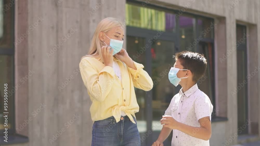 A beautiful young blonde and her son are walking the streets in medical ...