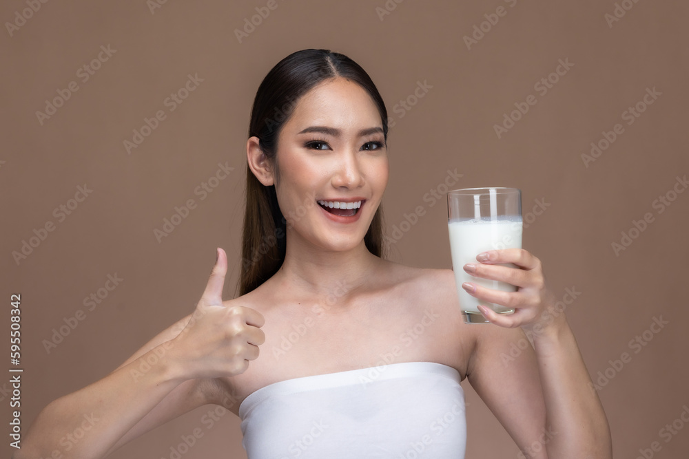 Asian beauty woman cute girl feel happy drinking milk for good health Happiness on Beige background. Asian beauty woman cute girl feel happy drinking milk for good health Happiness on Beige background.