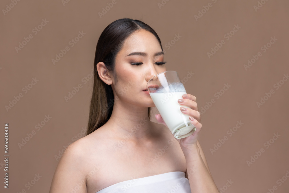 Asian beauty woman cute girl feel happy drinking milk for good health Happiness on Beige background. Asian beauty woman cute girl feel happy drinking milk for good health Happiness on Beige background.