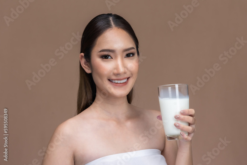 Asian beauty woman  cute girl feel happy drinking milk for good health Happiness  on Beige background.